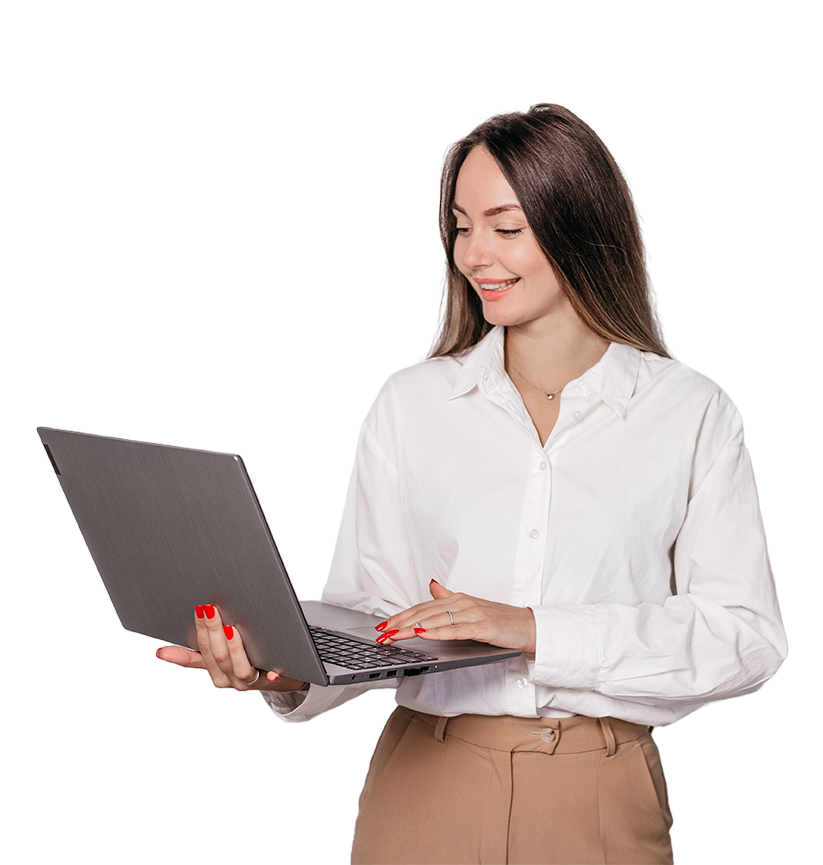a women standing, holding and working on her laptop